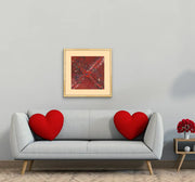 Planet B - Heart Art Original  - on light grey wall in living room with grey couch and two red hearts