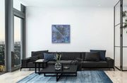 Framed Milky Way Galaxy In room with parquet floor, large black  couch and hanging on white wall