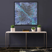 Framed Milky Way Galaxy hanging on dark grey wall In hall way with white marble table