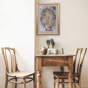 Queen Earth - Heart Art Original - on light grey wall with  small kitchen table and two kitchen chairs