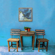 Blow Away Bad Memories - Heart Art Original  -  on sky blue wall with wooden chairs and a wooden table in the same style