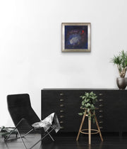 The Earth’s Origins - a Big Bang  - on white wall with dark filling cabinet and dark resting chair