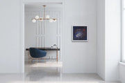 The Earth’s Origins - a Big Bang  - on white wall in space with ceiling lamp, blue chair and desk
